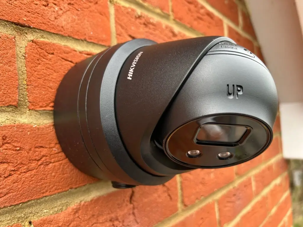 Black CCTV Camera mounted on brick wall